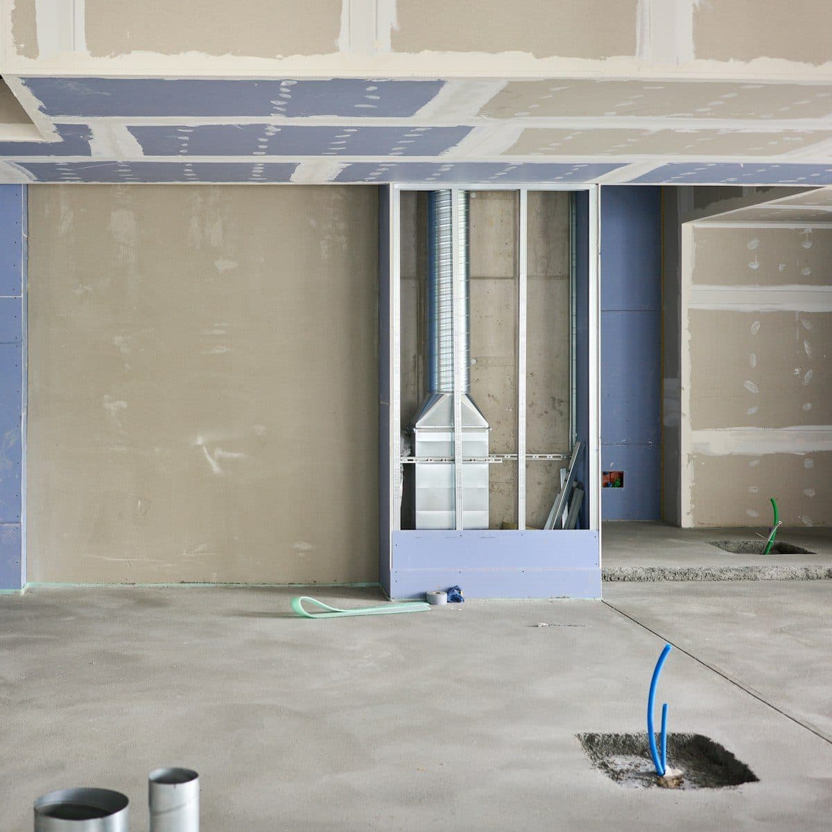 Commercial tenancy fit-out in progress, partition framing and a floor conduit stub